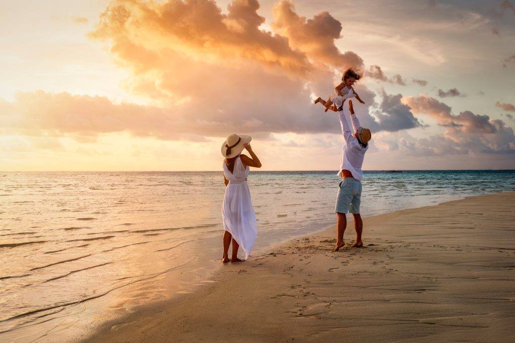 A family strolling on a beach at sunset, Karon Beach, Phuket